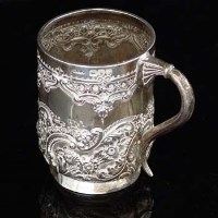 Lot 321 - Embossed silver christening mug