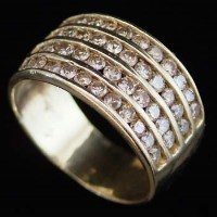 Lot 365 - Gold and diamond channel set ring