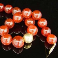 Lot 383 - Red agate bead necklace on silver clasp, length
