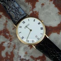 Lot 423 - Givano 18ct gold wrist watch, white face with