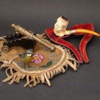 Lot 475 - Austrian cold painted bronze bird, a bronze miniature cannon, a negro meerscham pipe and an American native buckskin beedwork pouch (4)