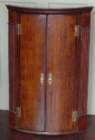 Lot 642 - Oak bow - fronted corner cabinet.