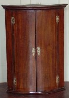 Lot 643 - Oak bow - fronted corner cabinet.