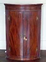 Lot 845 - Bow front mahogany corner cupboard