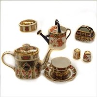 Lot 613 - Crown Derby miniature part teaset, watering can, basket and two thimbles