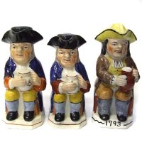 Lot 626 - Three Staffordshire lidded Toby jugs