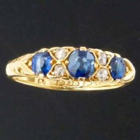 Lot 307 - Sapphire and diamond half hoop ring