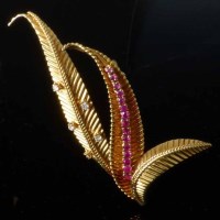Lot 311 - Ruby and diamond leaf brooch