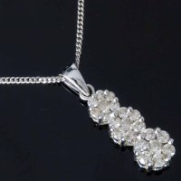 Lot 318 - Triple diamond cluster white gold pendant on