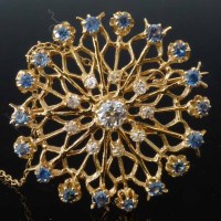 Lot 361 - Circular diamond and sapphire brooch