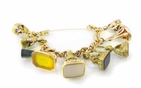 Lot 372 - A yellow gold charm bracelet complete with a total of 9 stone set seal charms