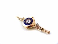 Lot 390 - Ladie's vintage 18K gold early wristwatch on a rolled gold bracelet