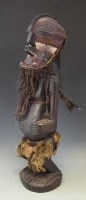 Lot 21 - Songye Nkisi power figure wearing Kifwebe mask