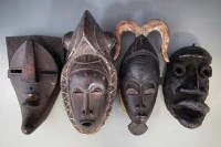 Lot 41 - Four masks, carved in Bete, Guro, Yaure, and Lulua tribal styles, the largest measures 42cm high