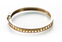 Lot 173 - A citrine set 14ct gold hinged bangle