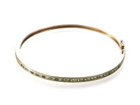 Lot 174 - An emerald and diamond set 14ct gold hinged bangle