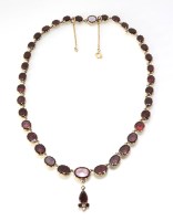 Lot 187 - A Victorian yellow gold garnet set riviere necklace