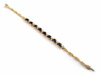 Lot 295 - A sapphire and diamond 14ct yellow gold bracelet, 8 oval sapphires, each seperated by 2 small diamonds (18 diamonds total), length approx. 18.2cm, gro