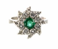 Lot 314 - Emerald and diamond 18ct white gold flower head cluster ring