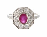 Lot 322 - A ruby and diamond octagonal cluster 18ct white gold ring, central oval mixed cut ruby approx. 6mm x 5mm, cluster surround of 10 round brilliant cut d