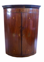 Lot 462 - George III mahogany two door bow-front corner cupboard