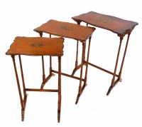 Lot 484 - Early 20th century satin wood nest of three graduated tables