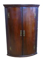 Lot 416 - George III mahogany corner cupboard.