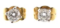 Lot 404 - Pair of diamond solitaire 18ct gold stud earrings