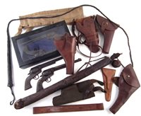 Lot 81 - A collection of five holsters, arrow quiver, case of Victorian shop display revolvers and whip