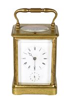 Lot 658 - A 19th century brass carriage clock with foliate engraving