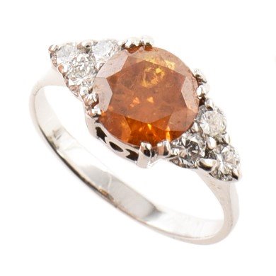 Lot 87 - Fancy deep yellow-orange diamond solitaire ring